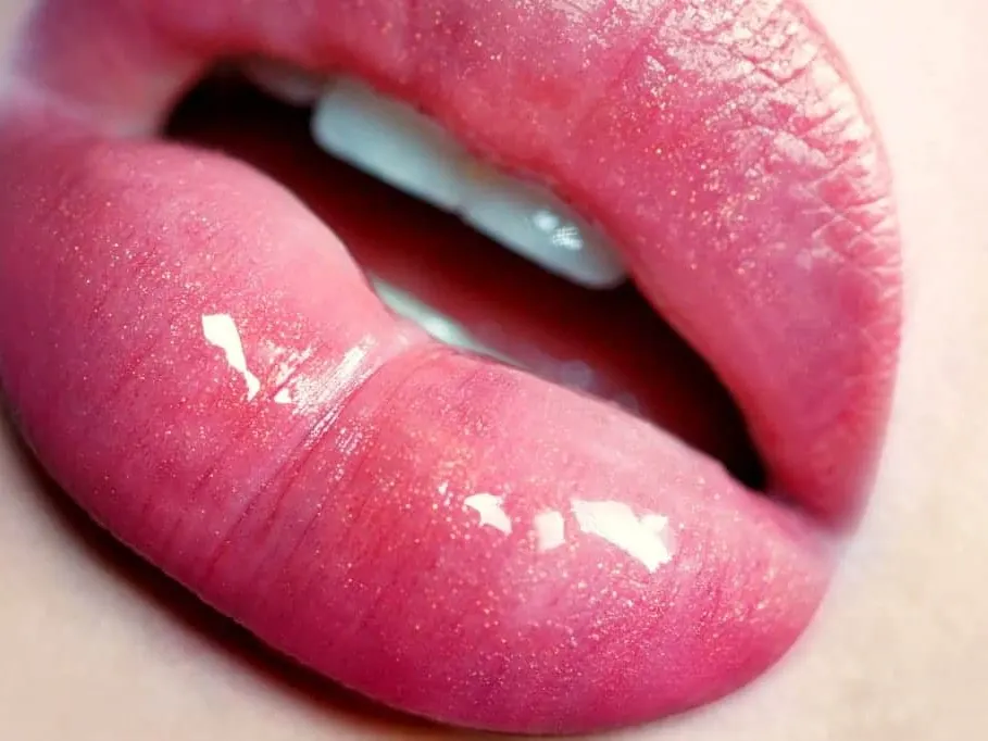 Close-up of glossy pink lips