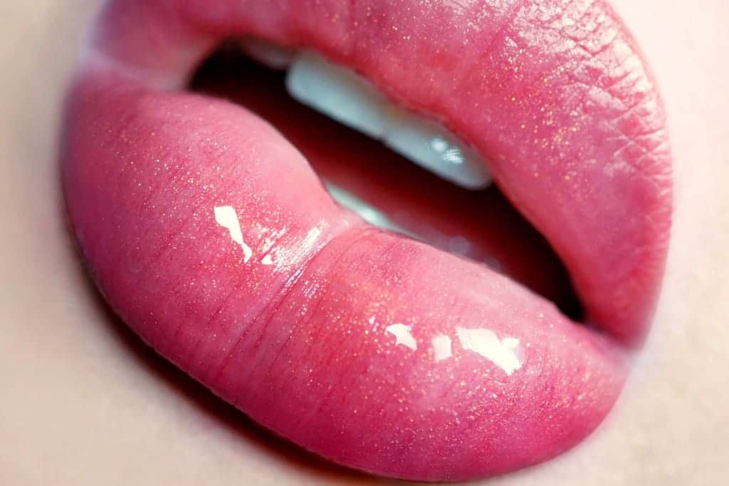 Close-up of glossy pink lips