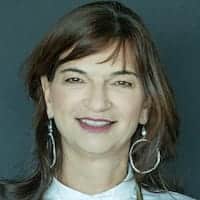 Agnese Canazza, Medical Assistant, smiling, with brown hair and large hoop earrings