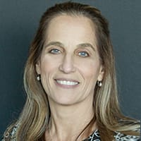 Raquel Fuertes, Medical Coordinator, smiling, with long light-brown hair
