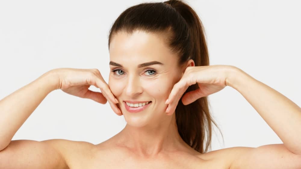 Beautiful mature woman with glowing skin after Morpheus8 microneedling treatment.