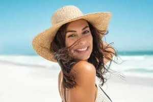 woman wearing a sunhat and smiling at the camera